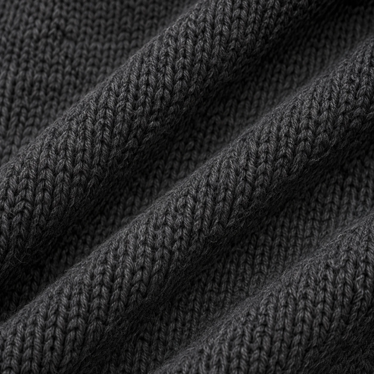 Illustrative charcoal knitted fabric with diagonal folds